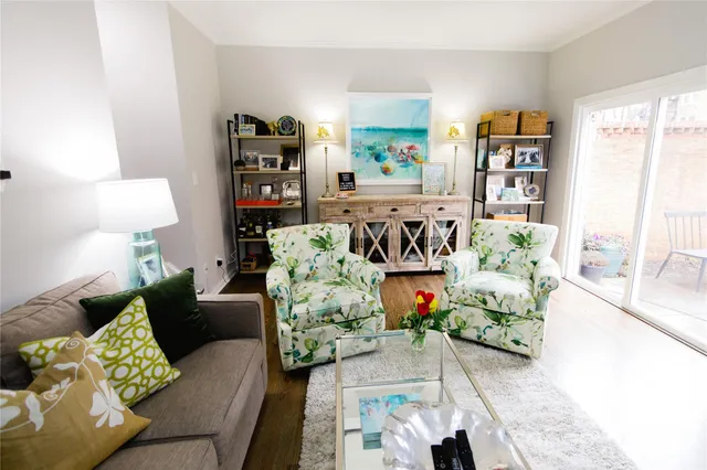 a living room with furniture and a book shelf