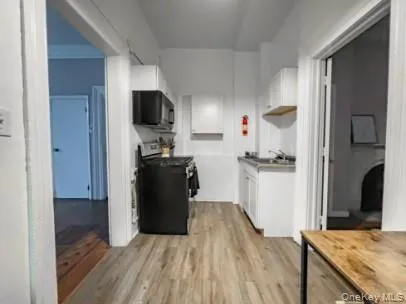 a kitchen with a refrigerator and a stove top oven