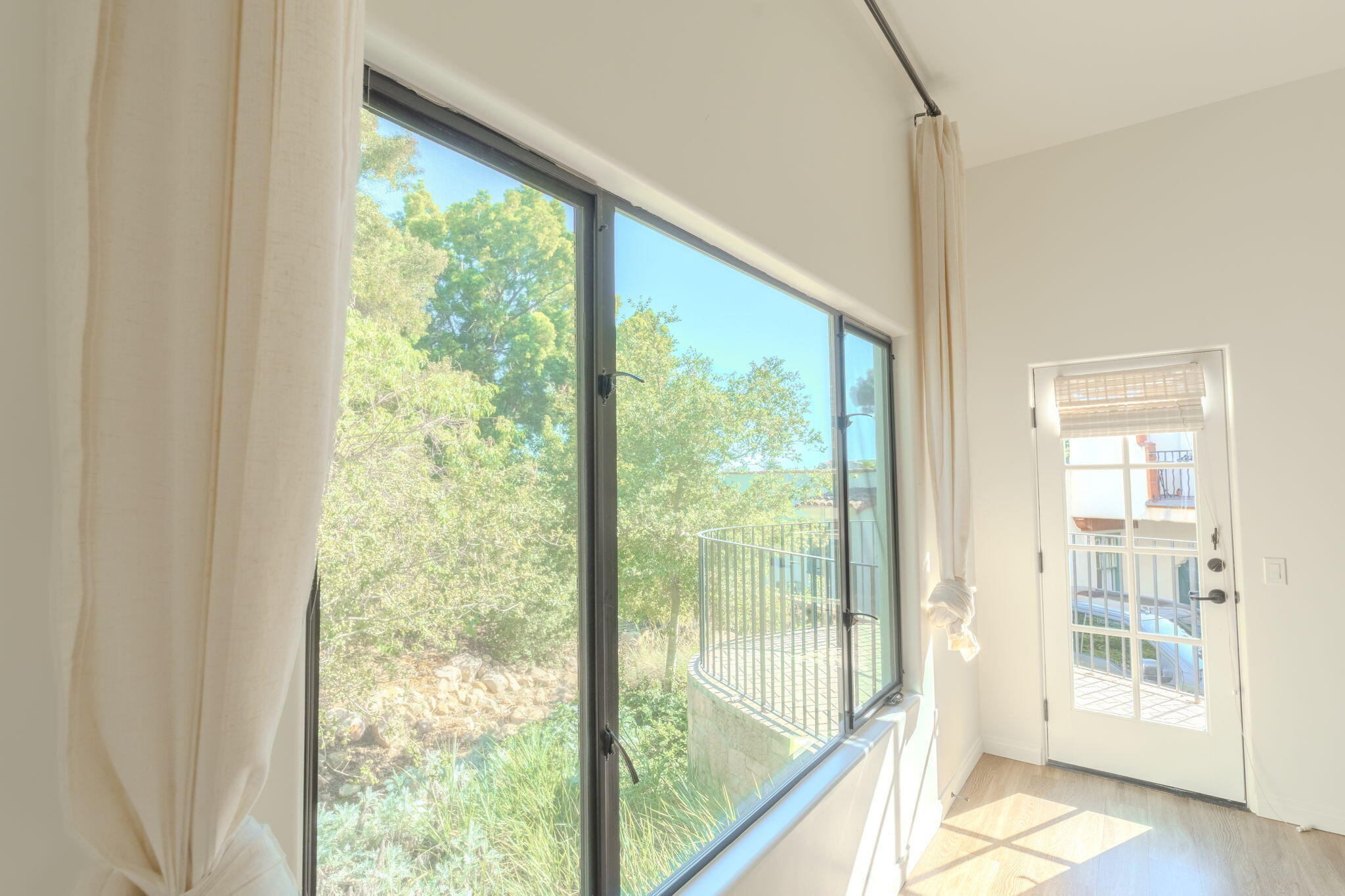 920 Lowena Drive, Unit 19 Santa Barbara, CA 93103 - Photo 4 of 21 a view of an empty room with wooden floor and a window