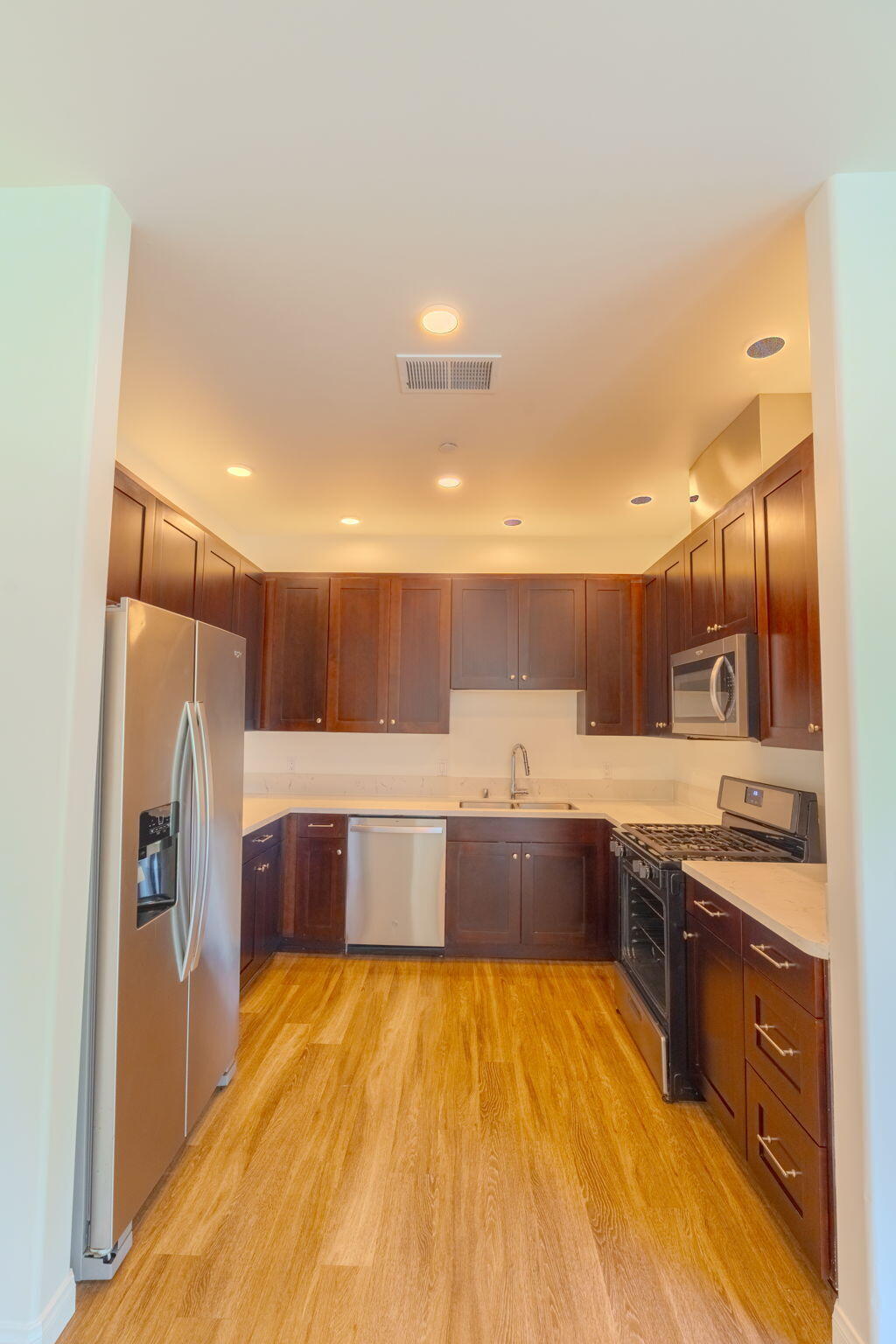 920 Lowena Drive, Unit 19 Santa Barbara, CA 93103 - Photo 7 of 21 a large kitchen with stainless steel appliances kitchen island granite countertop a sink and cabinets