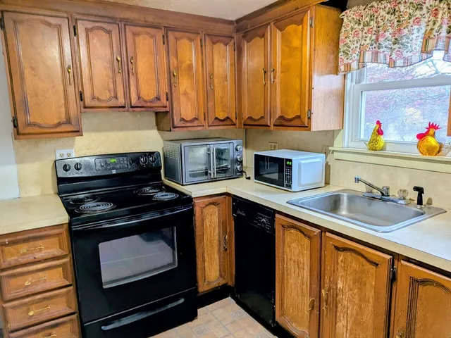 a kitchen with stainless steel appliances a stove sink and cabinets
