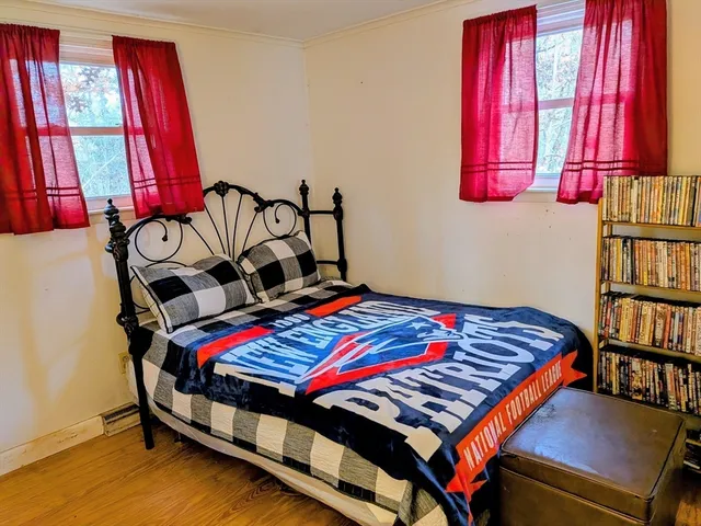 a bedroom with a bed and window