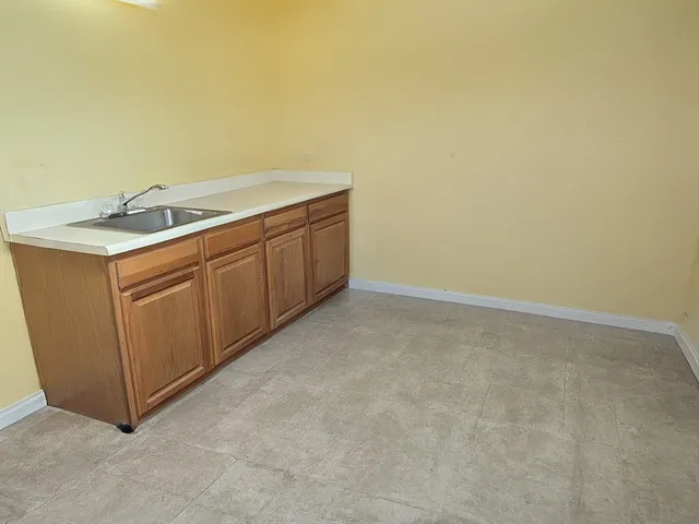 a utility room with sink dryer and washer