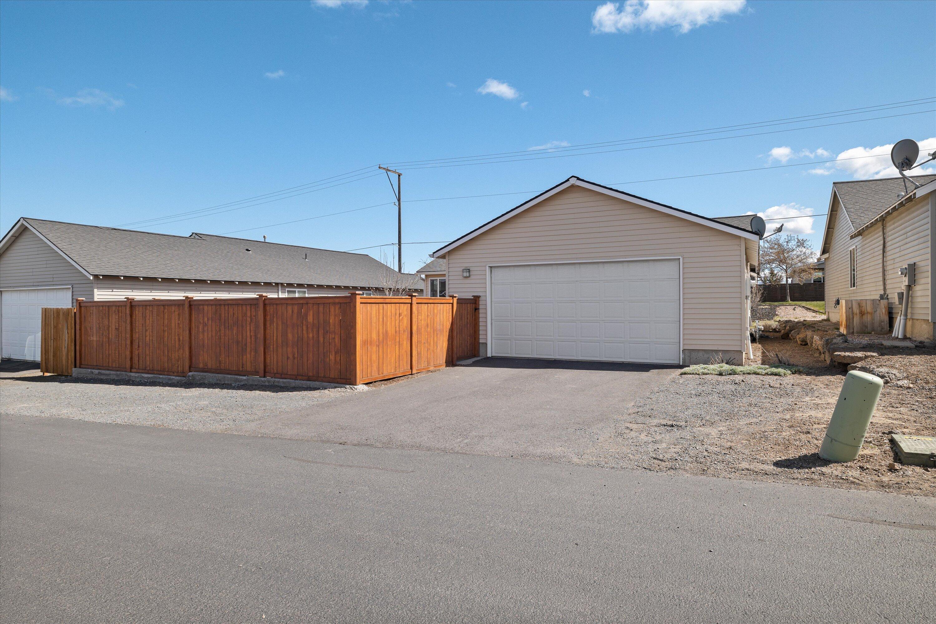 63169 Boyd Acres Road Bend, OR 97701 - Photo 23 of 23 2 car garage with additional parking along the fence