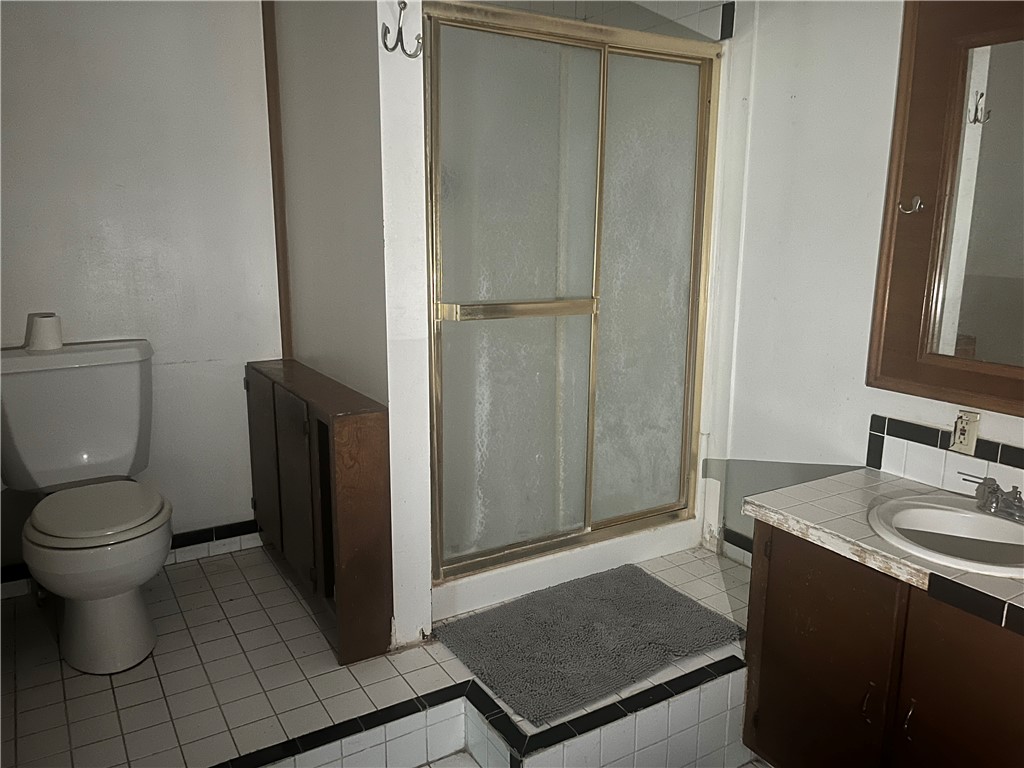 305 East Laredo Street Freer, TX 78357 - Photo 14 of 19 a bathroom with a sink and a toilet