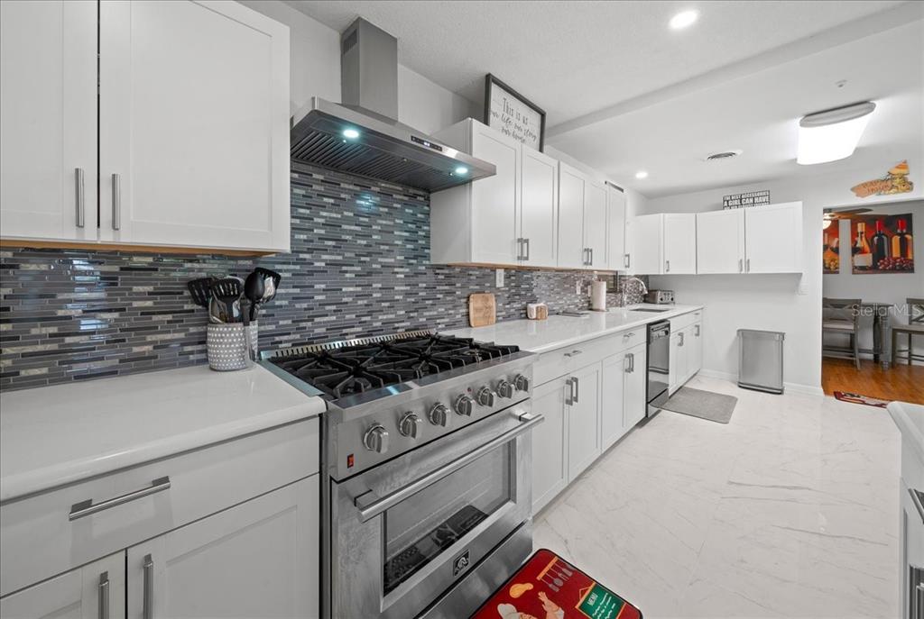 4367 Northeast 11th Street Ocala, FL 34470 - Photo 11 of 24 a kitchen with a white cabinets and stove
