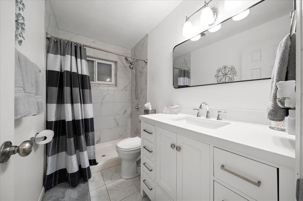 4367 Northeast 11th Street Ocala, FL 34470 - Photo 12 of 24 a bathroom with a sink and a mirror