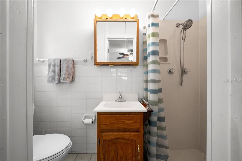 4367 Northeast 11th Street Ocala, FL 34470 - Photo 16 of 24 a bathroom with a sink a toilet and shower