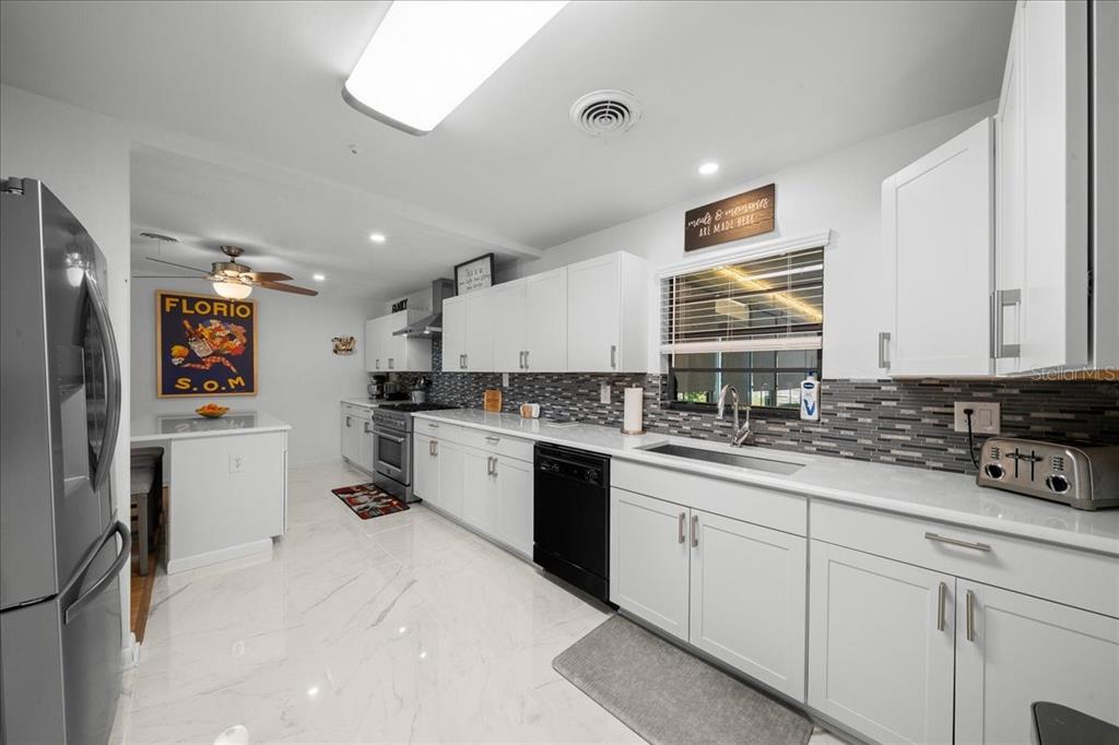 4367 Northeast 11th Street Ocala, FL 34470 - Photo 10 of 24 a kitchen with white cabinets and refrigerator