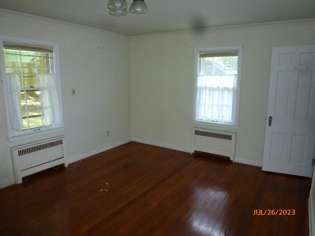 920 Innis St Extension Oil City, PA 16301 - Photo 13 of 21 an empty room with wooden floor and windows