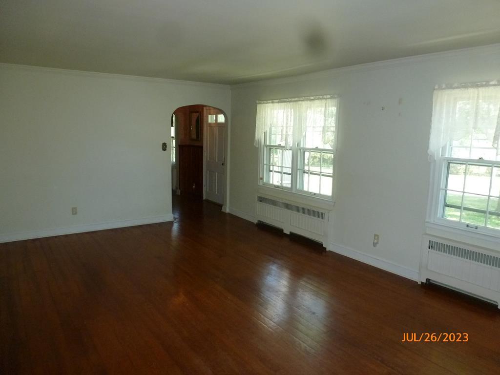 920 Innis St Extension Oil City, PA 16301 - Photo 4 of 21 an empty room with wooden floor and windows