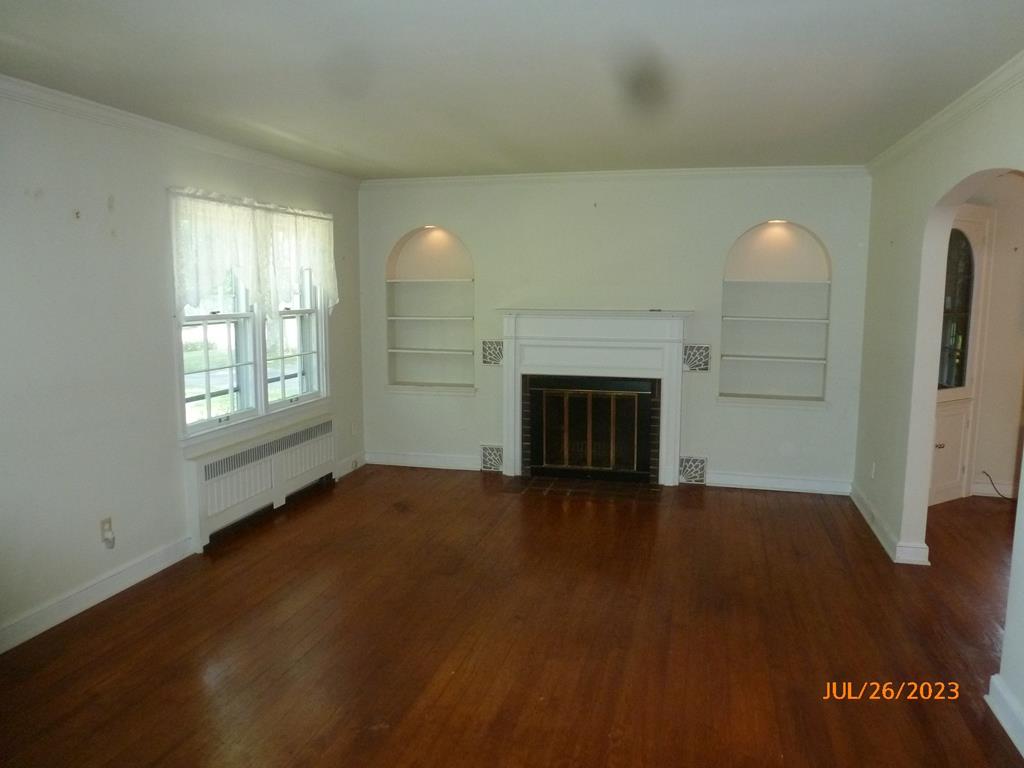 920 Innis St Extension Oil City, PA 16301 - Photo 5 of 21 an empty room with windows and fireplace