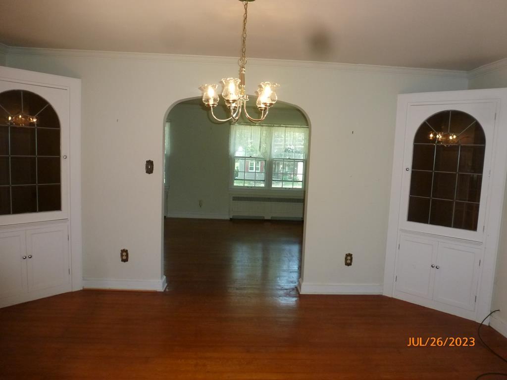 920 Innis St Extension Oil City, PA 16301 - Photo 8 of 21 a view of an empty room with a window and wooden floor