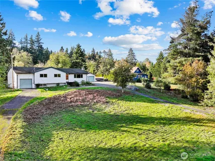 a view of a house with a yard and sitting area