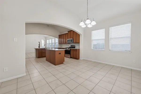 a kitchen with stainless steel appliances granite countertop a sink a stove a microwave and cabinets