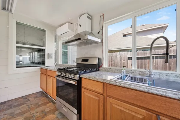 a kitchen with stainless steel appliances granite countertop a stove and a microwave