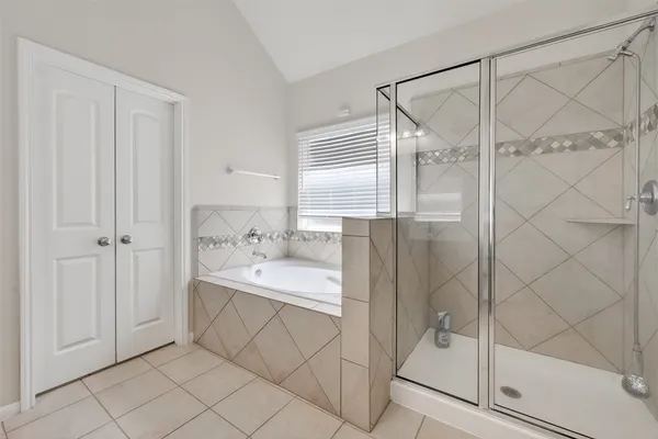 a bathroom with a bathtub and a shower