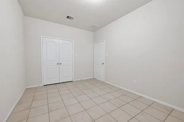 a view of a room with wooden floor and a window