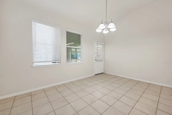 a kitchen with granite countertop a sink a counter top space and cabinets