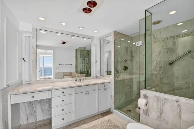 a kitchen with a sink and a stove top oven with white cabinets