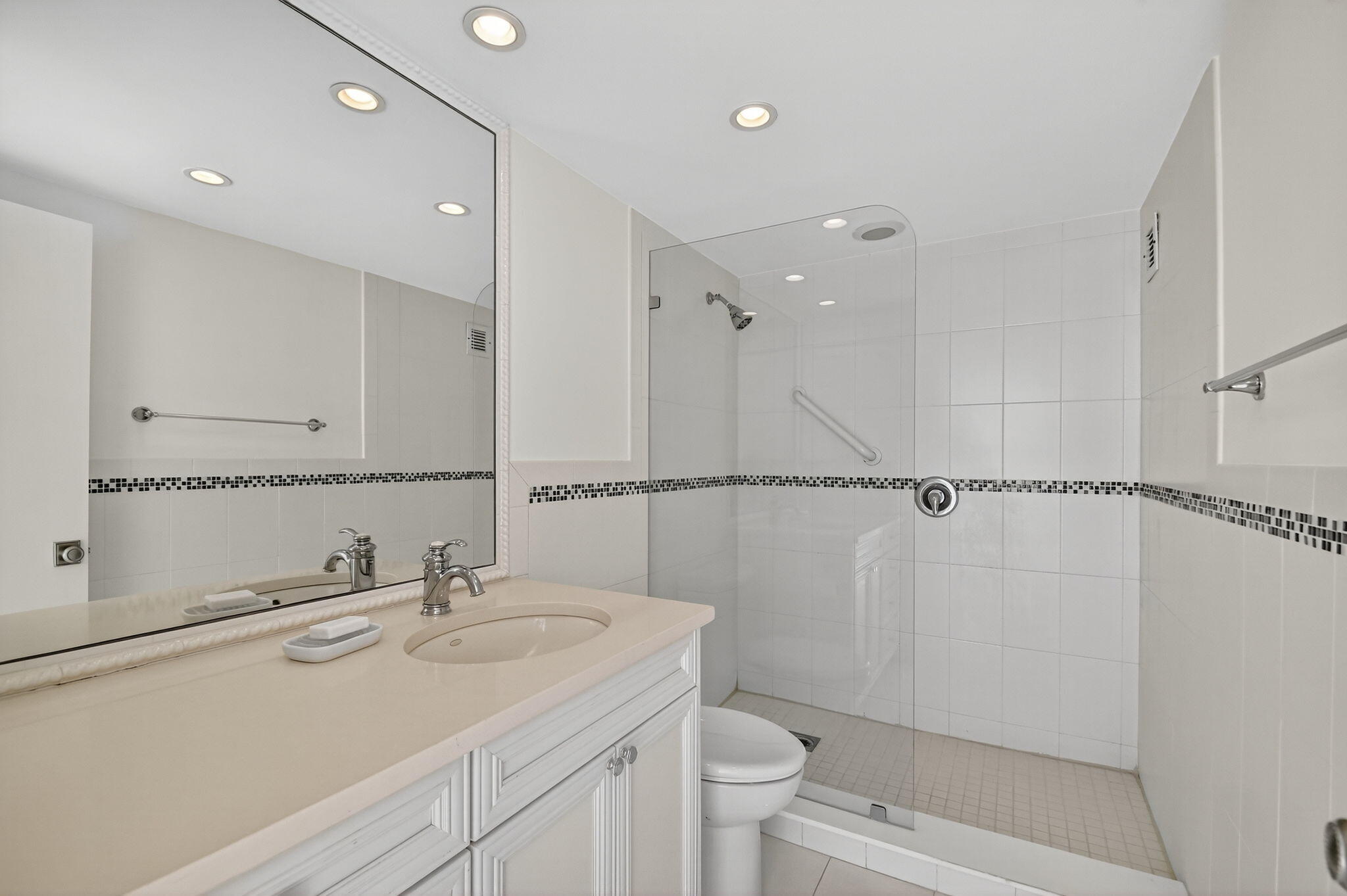 2780 South Ocean Boulevard, Unit 703 Palm Beach, FL 33480 - Photo 27 of 44 a bathroom with a sink toilet a mirror and shower