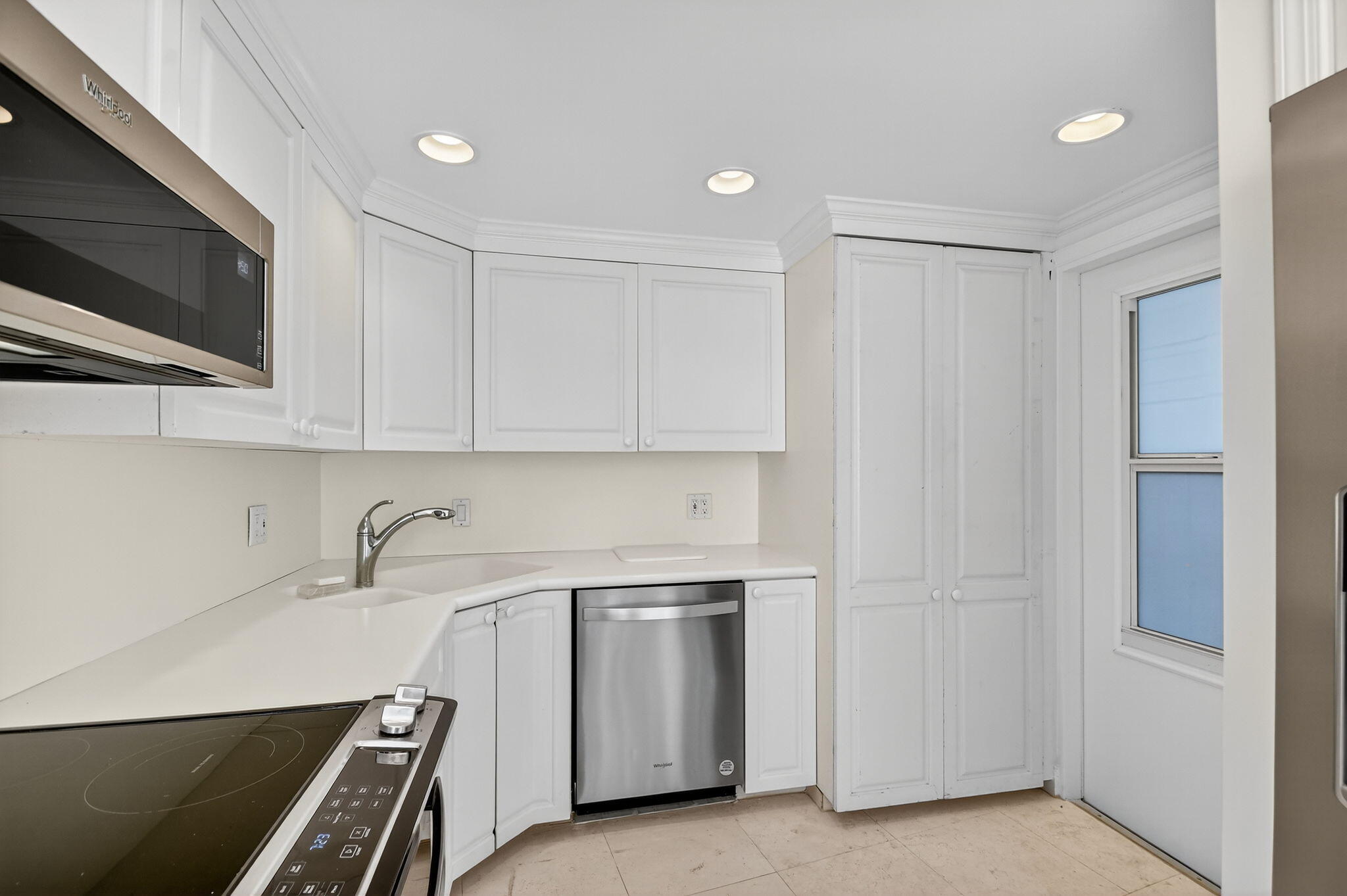 2780 South Ocean Boulevard, Unit 703 Palm Beach, FL 33480 - Photo 32 of 44 a kitchen with stainless steel appliances a stove and a microwave