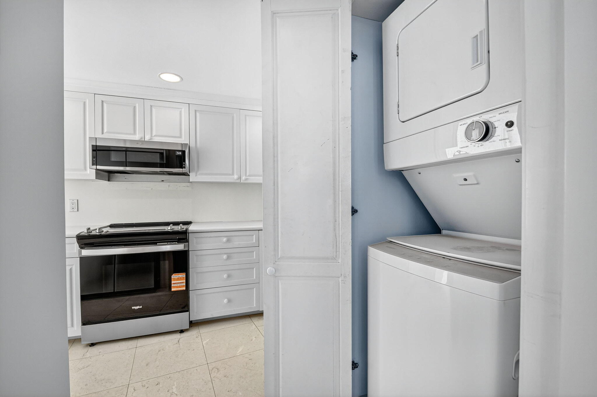 2780 South Ocean Boulevard, Unit 703 Palm Beach, FL 33480 - Photo 33 of 44 a kitchen with cabinets and steel stainless steel appliances