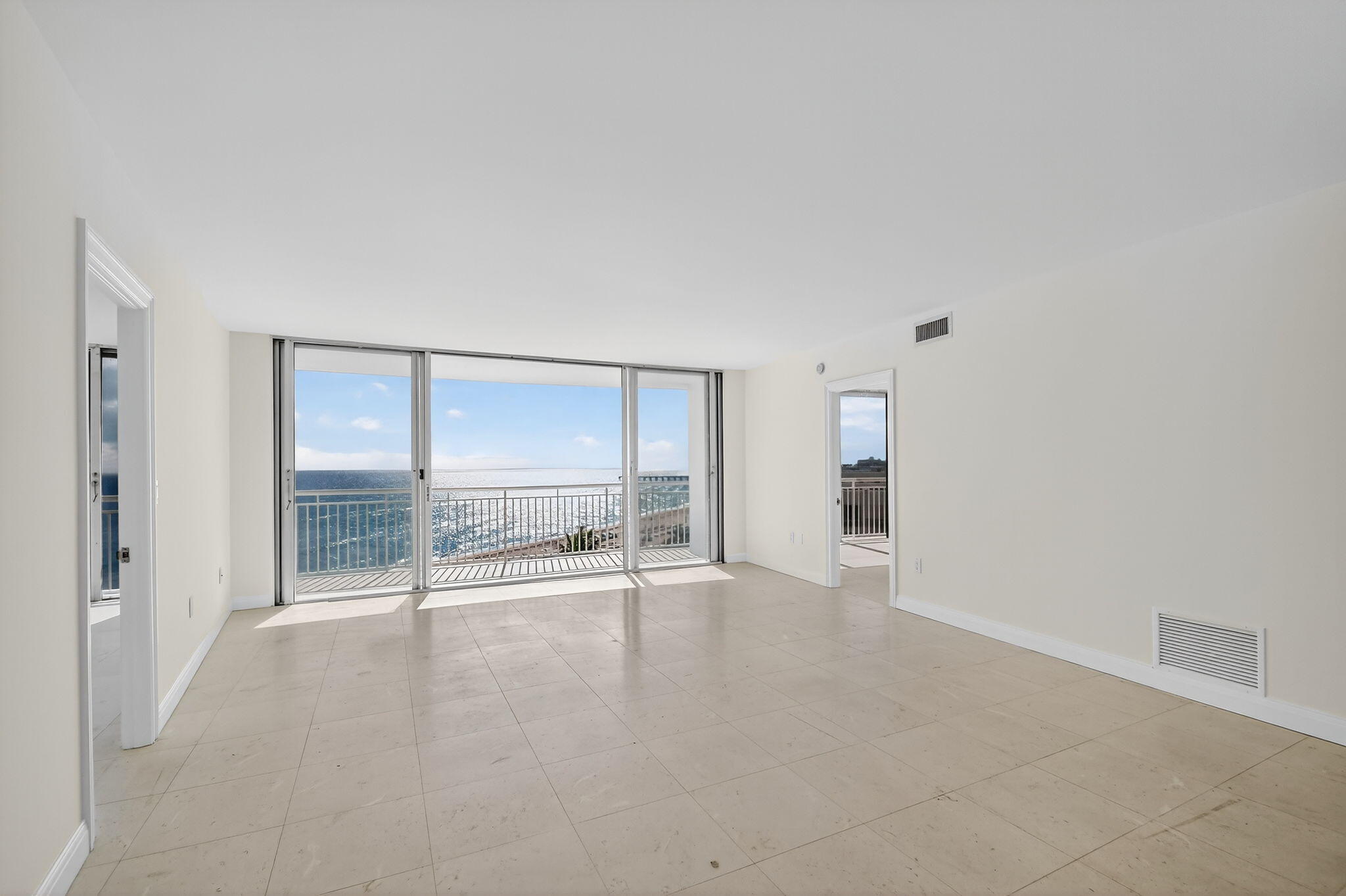 2780 South Ocean Boulevard, Unit 703 Palm Beach, FL 33480 - Photo 6 of 44 an empty room with large windows