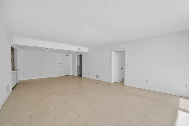a view of an empty room with a balcony