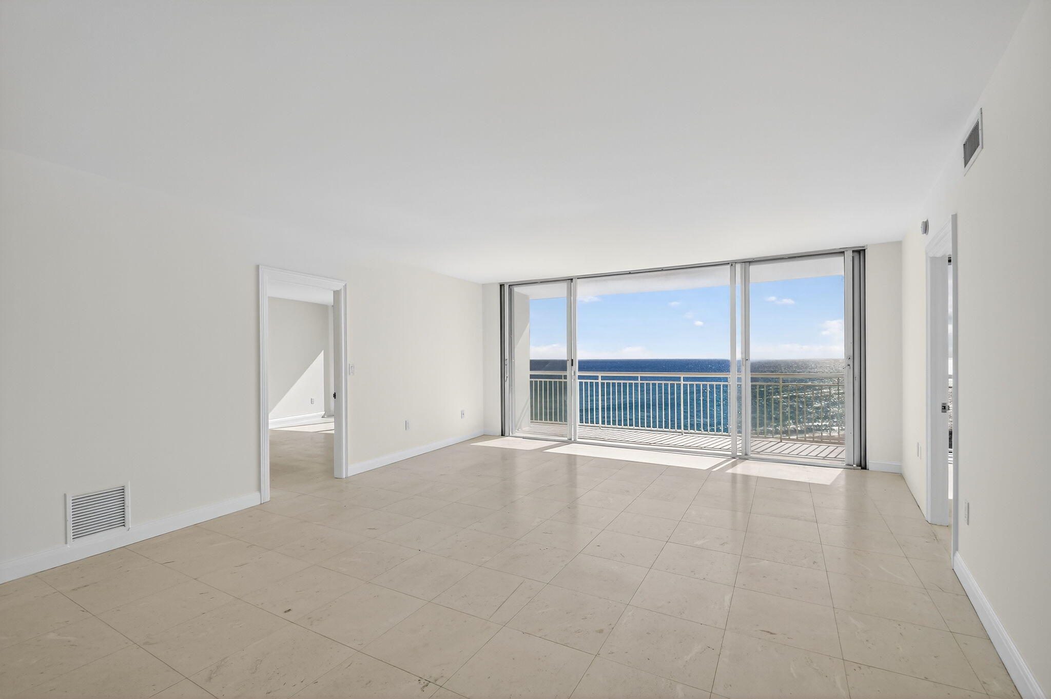 2780 South Ocean Boulevard, Unit 703 Palm Beach, FL 33480 - Photo 9 of 44 an empty room with wooden floor and windows