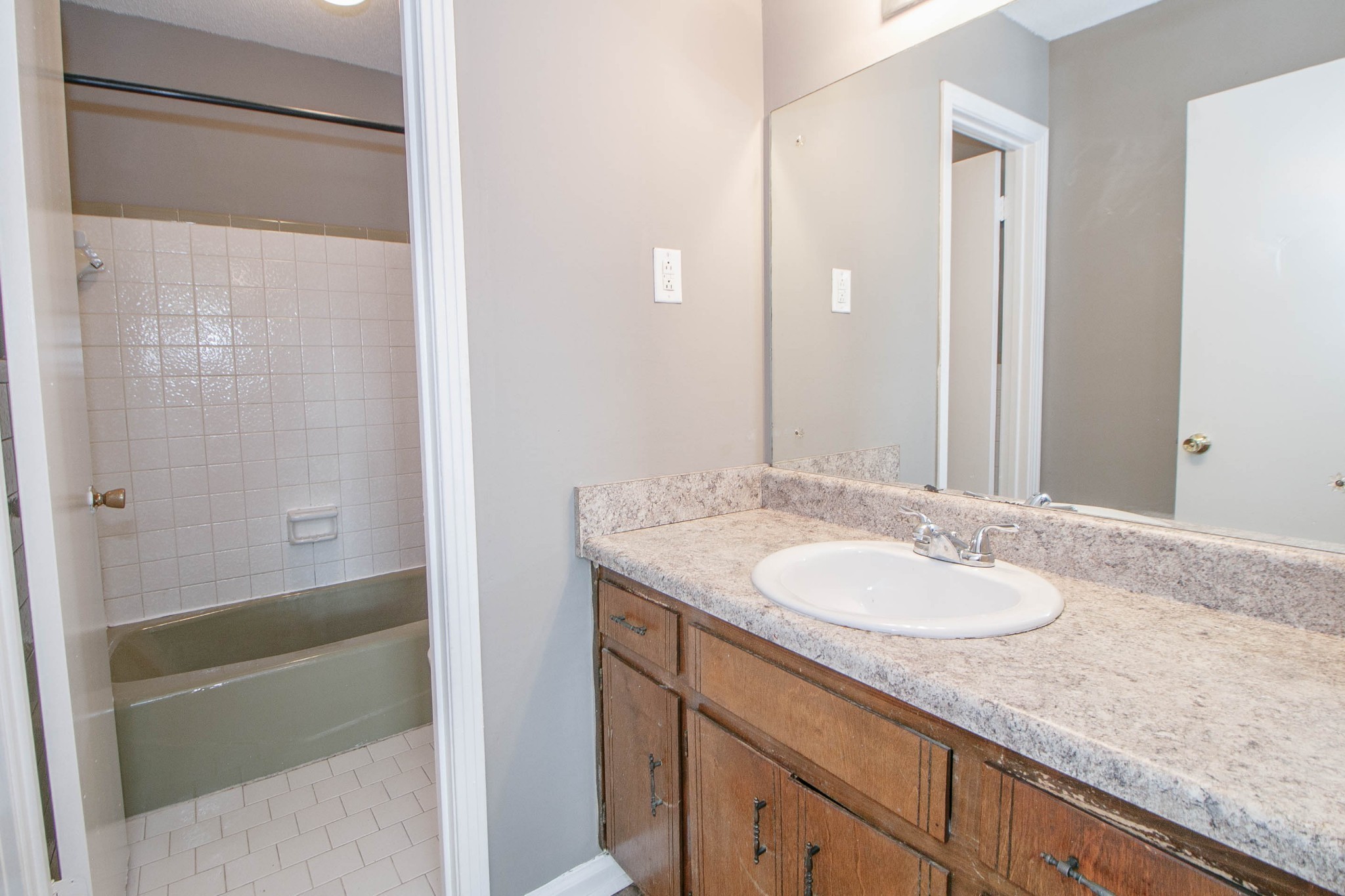 807 Golf View Place, Unit C Clarksville, TN 37043 - Photo 14 of 24 a bathroom with a granite countertop sink and a mirror