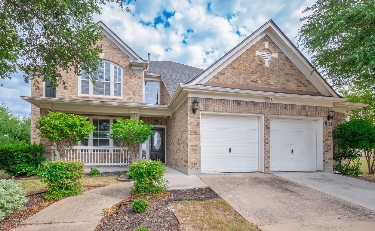 406 Primavera Loop Kyle, TX 78640 - Photo 1 of 38 a view of a white house with a large window and potted plants