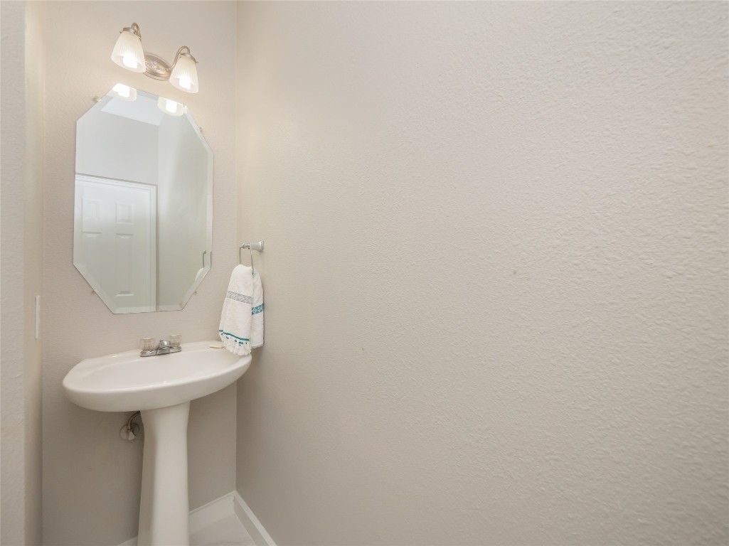 406 Primavera Loop Kyle, TX 78640 - Photo 21 of 38 a bathroom with a sink and a mirror
