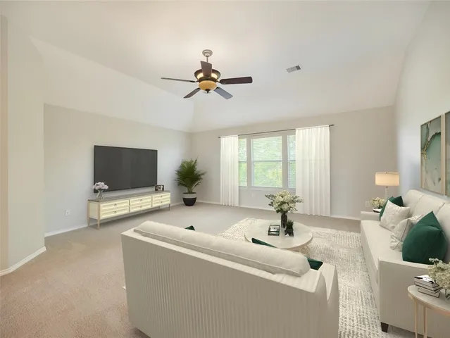 an empty room with fan and windows