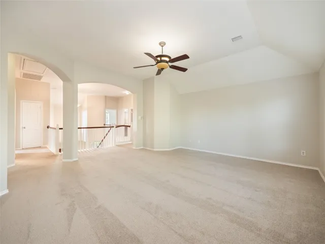 a bedroom with a large bed and a potted plant