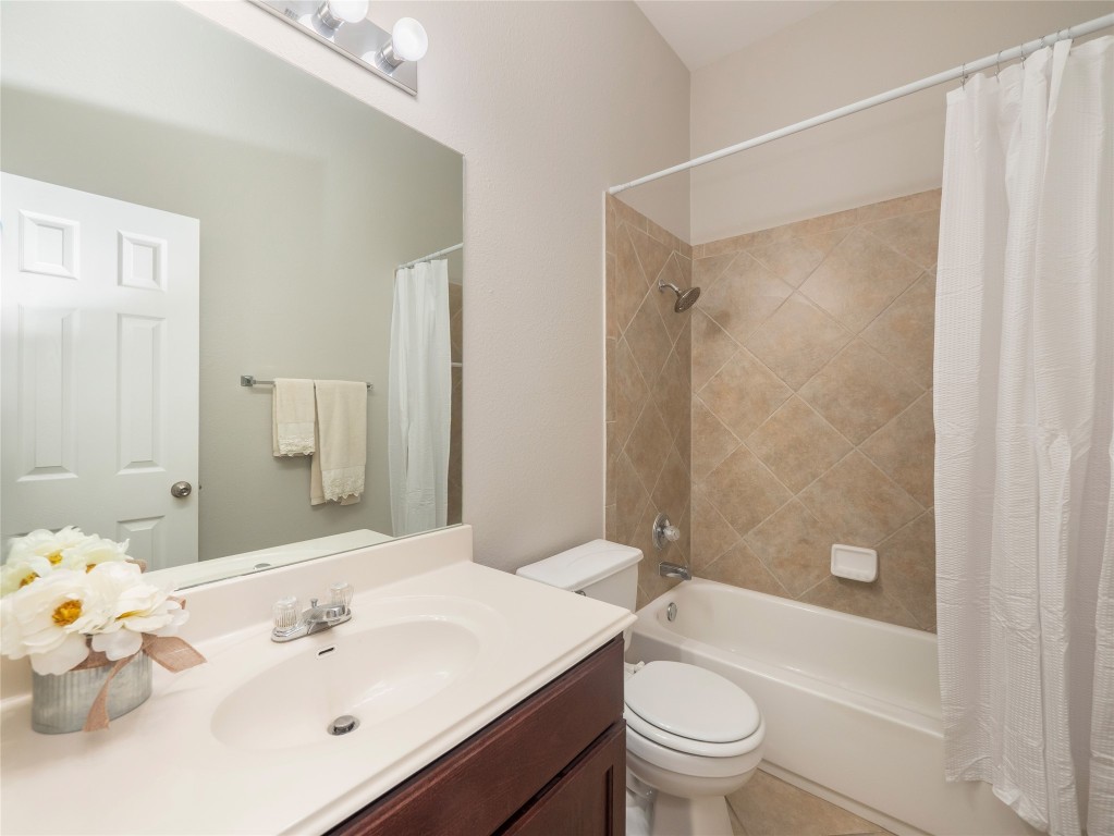 406 Primavera Loop Kyle, TX 78640 - Photo 28 of 38 a bathroom with a sink a toilet and shower