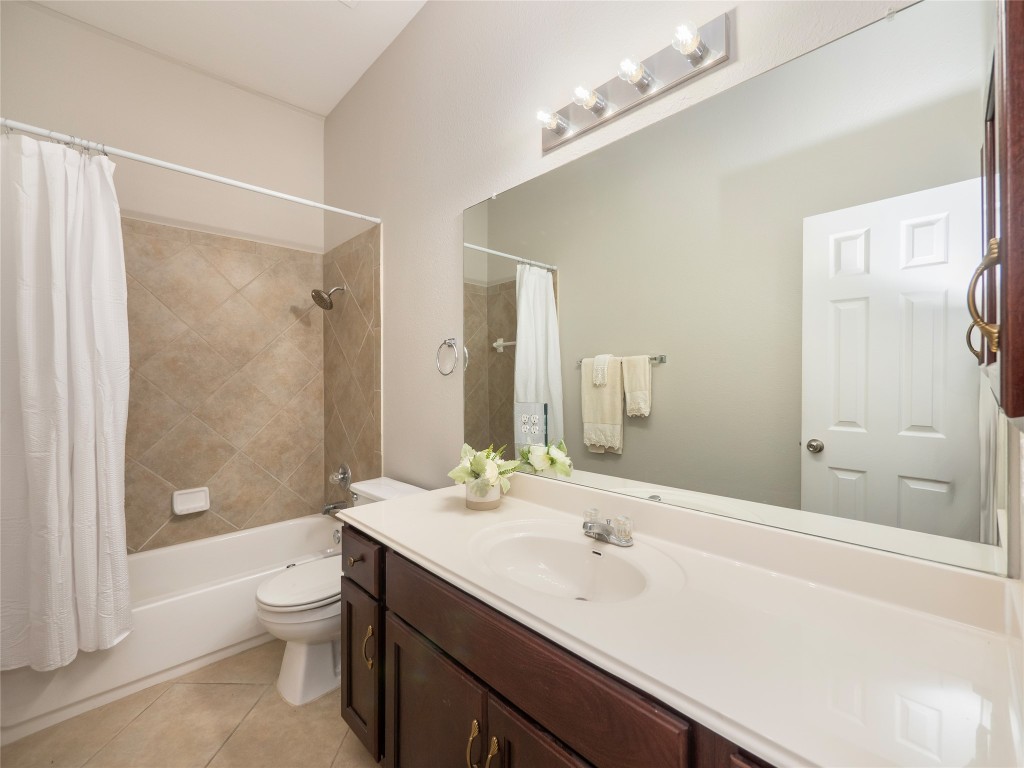 406 Primavera Loop Kyle, TX 78640 - Photo 31 of 38 a bathroom with a sink a toilet and shower