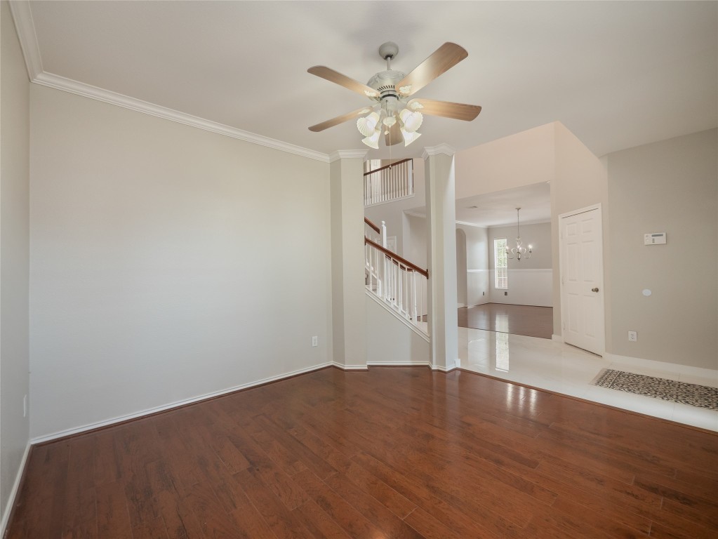 406 Primavera Loop Kyle, TX 78640 - Photo 5 of 38 a view of an empty room with wooden floor and a ceiling fan