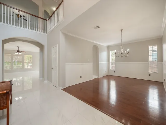 a view of a livingroom with wooden floor and a staircase