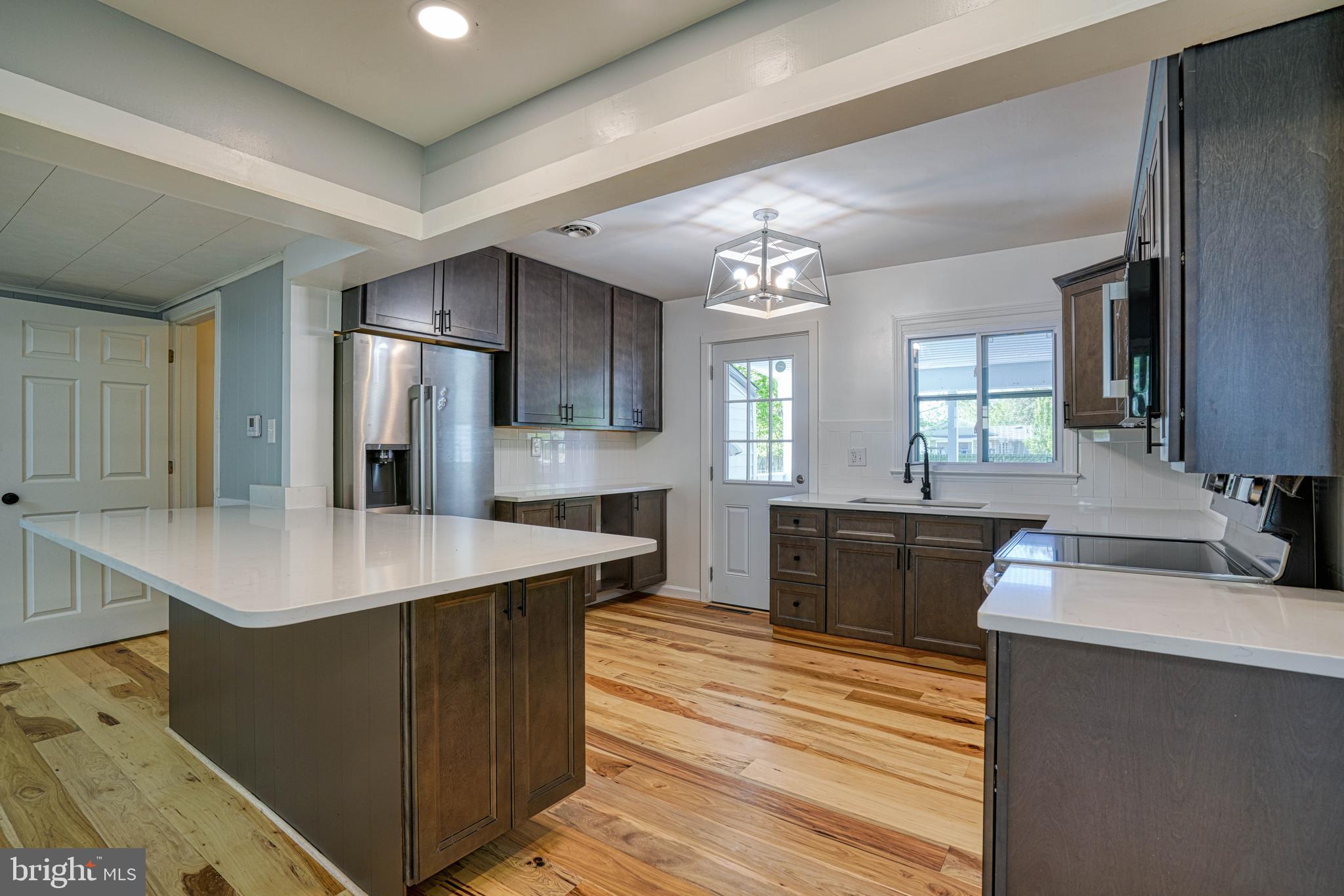 10 Bay View Avenue Cambridge, MD 21613 - Photo 12 of 28 a large kitchen with kitchen island a sink stainless steel appliances and cabinets