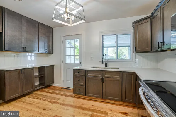 a kitchen with a stove sink and cabinets