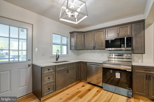 a kitchen with a sink stove and microwave