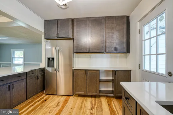 a kitchen with stainless steel appliances granite countertop a refrigerator and a stove top oven