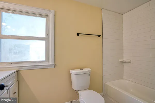 a bathroom with a toilet and a bathtub
