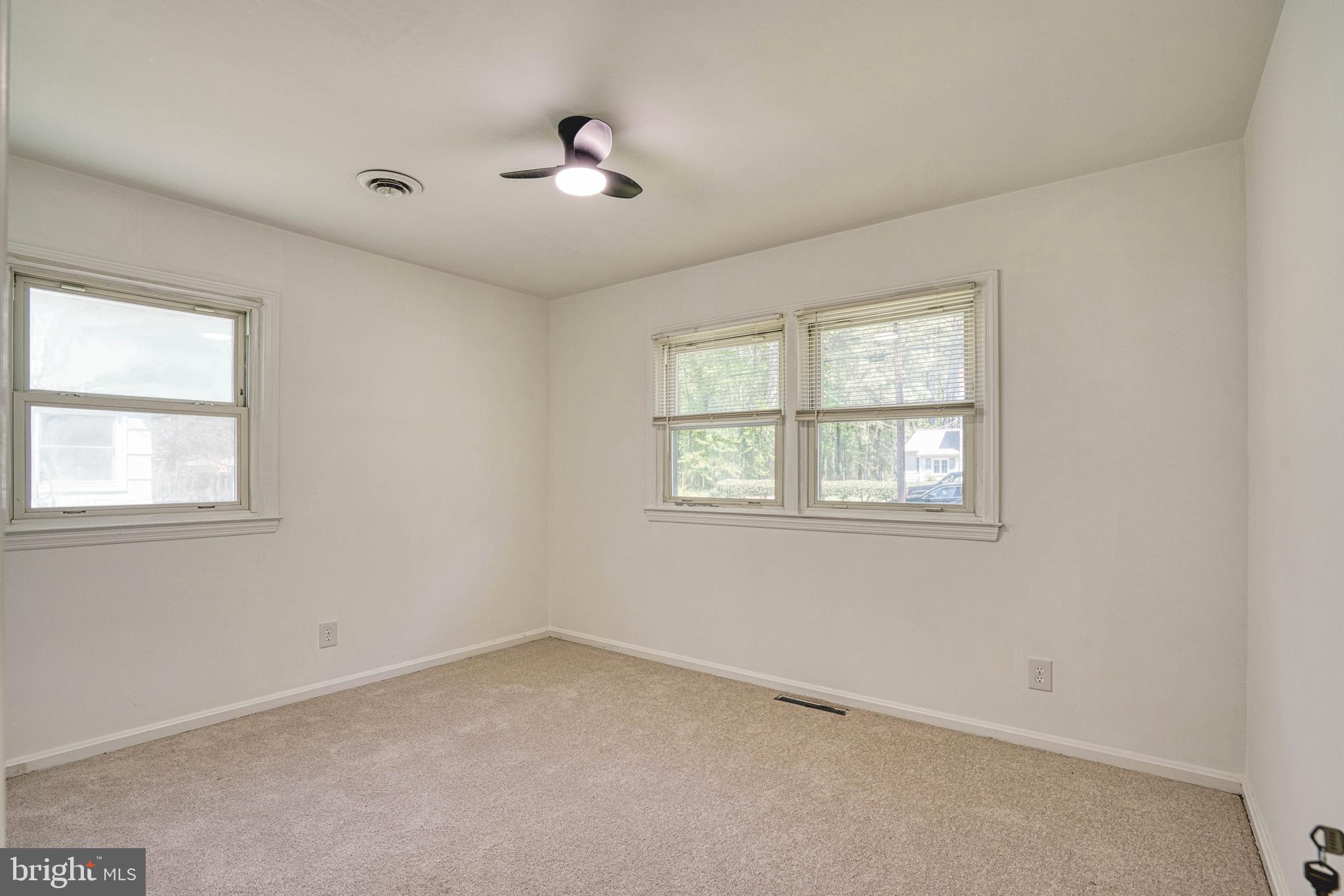 10 Bay View Avenue Cambridge, MD 21613 - Photo 21 of 28 an empty room with windows and fan
