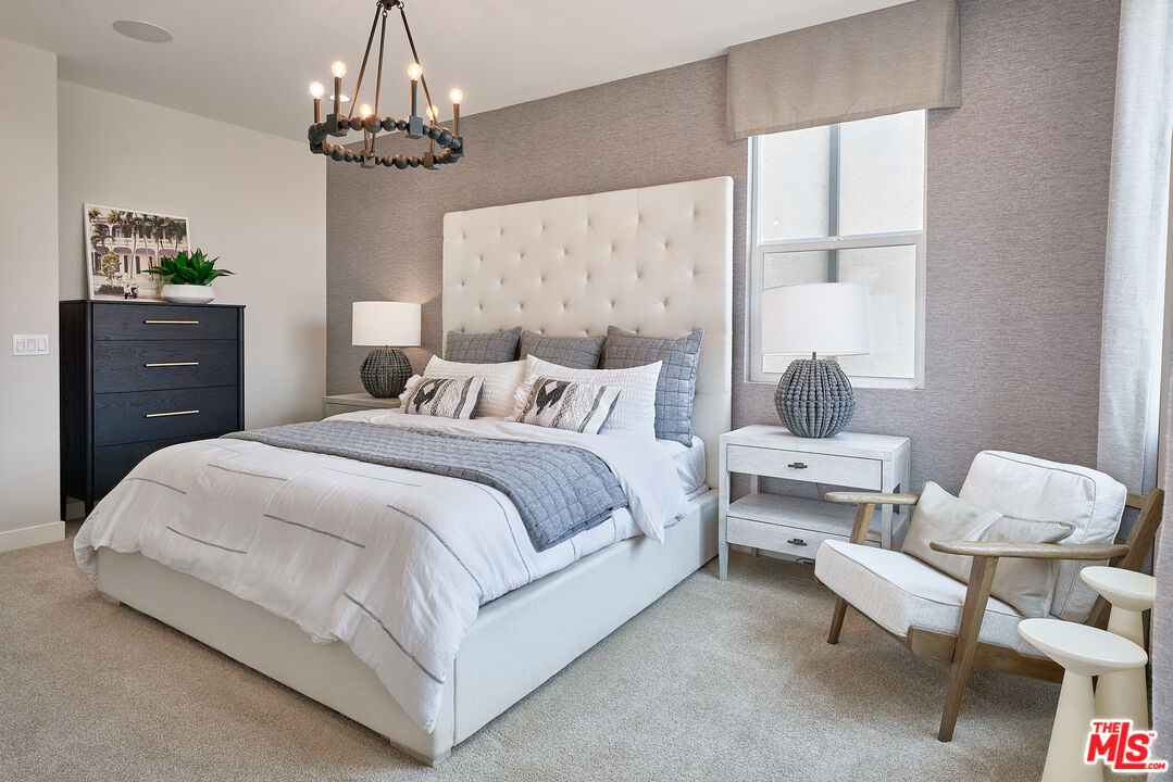525 Daniel Freeman Circle Inglewood, CA 90301 - Photo 15 of 39 a spacious bedroom with a bed and a chandelier