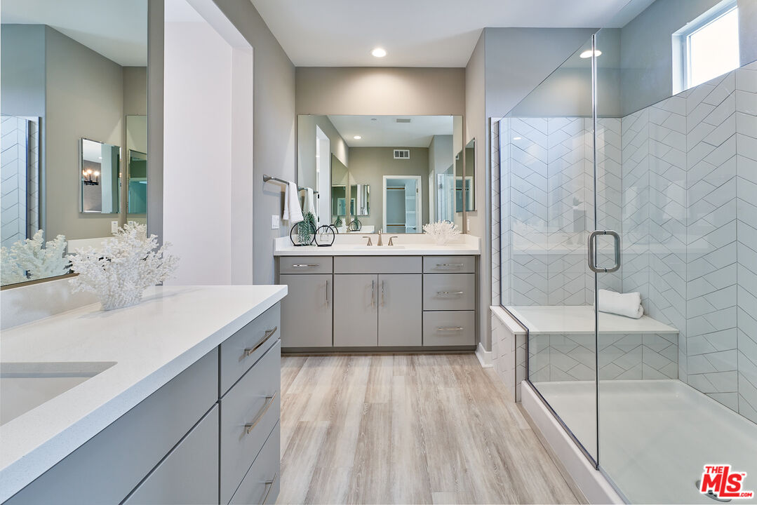 525 Daniel Freeman Circle Inglewood, CA 90301 - Photo 16 of 39 a bathroom with a double vanity sink a mirror and shower
