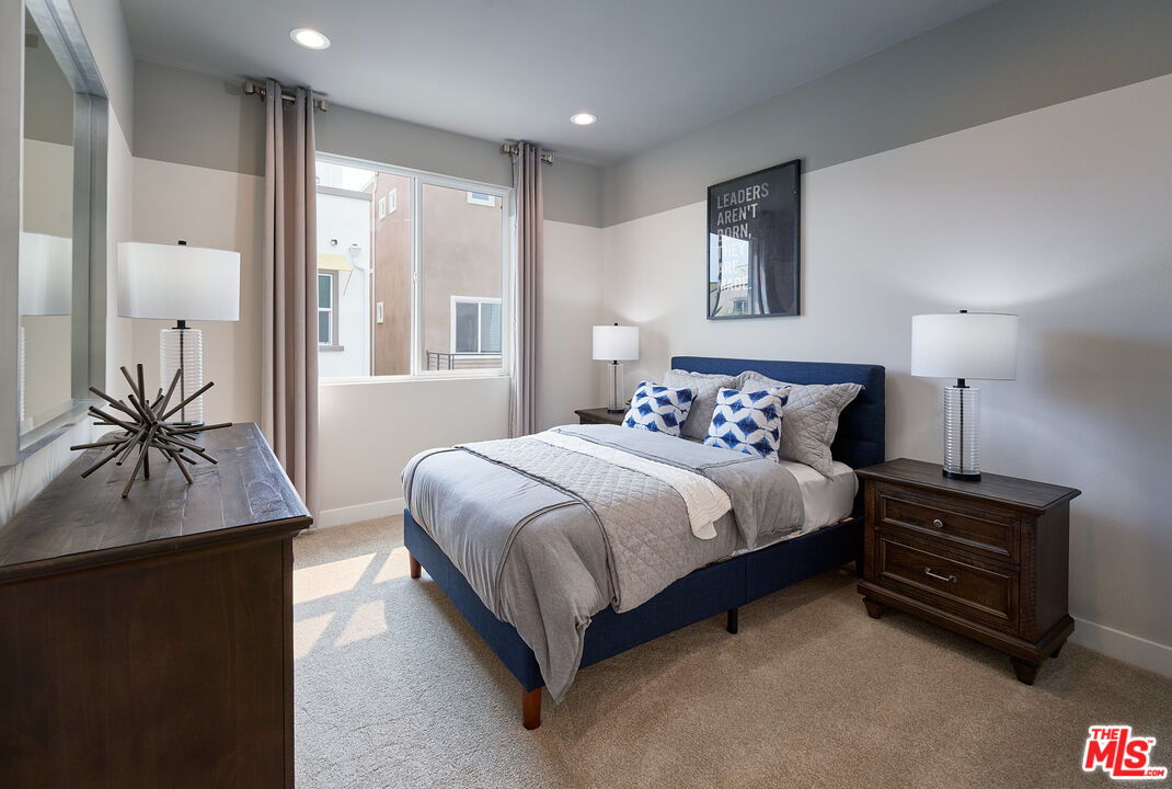 525 Daniel Freeman Circle Inglewood, CA 90301 - Photo 22 of 39 a bedroom with a bed and a potted plant