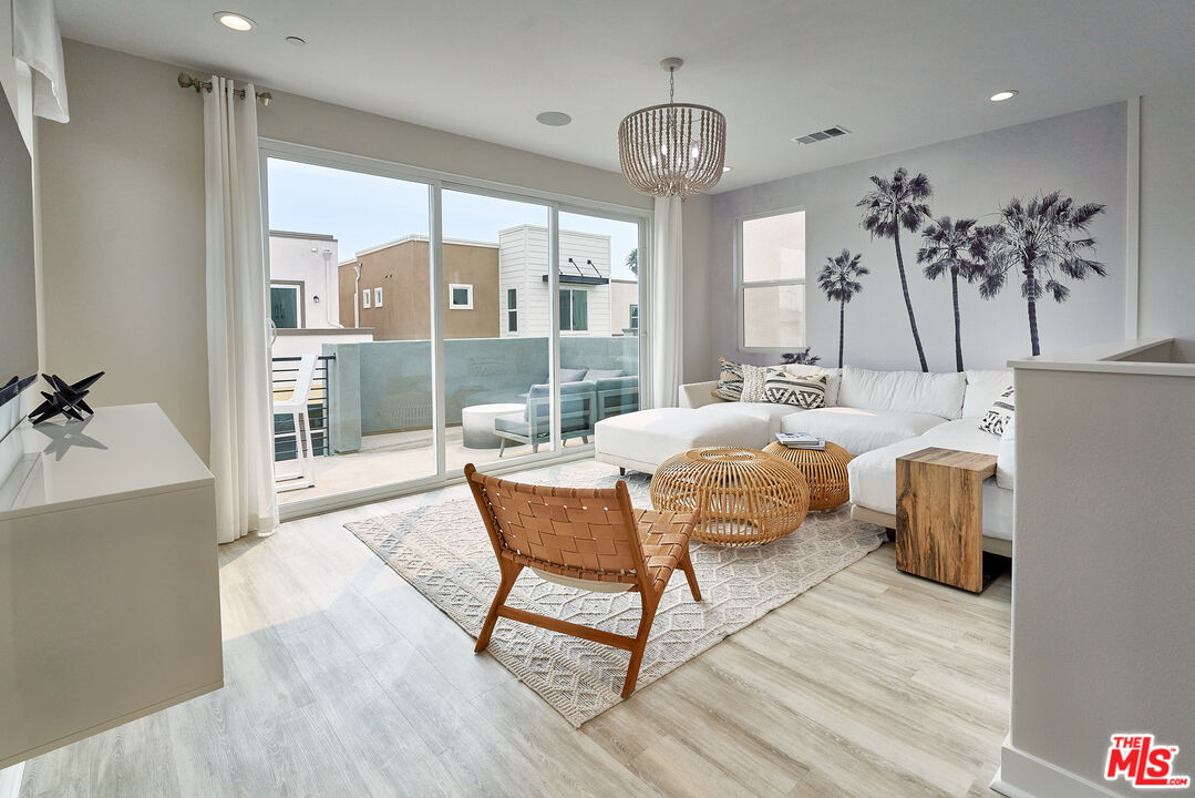 525 Daniel Freeman Circle Inglewood, CA 90301 - Photo 24 of 39 a living room with furniture a chandelier and wooden floor
