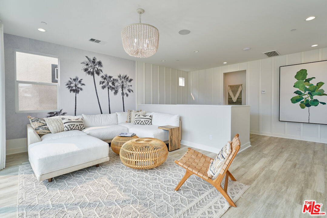 525 Daniel Freeman Circle Inglewood, CA 90301 - Photo 25 of 39 a living room with furniture and a chandelier